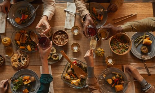 Above view background of multi-ethnic group of people enjoying feast during dinner party with friends and family